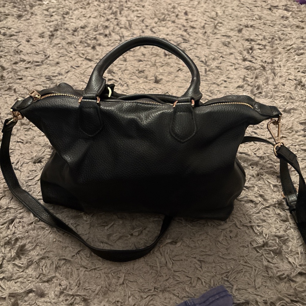 Black leather shoulder bag with gold hardware and adjustable straps